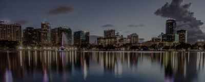 a bridge over a body of water with a city in the background