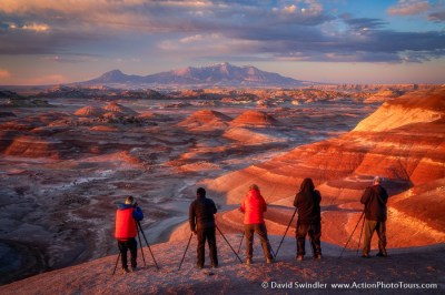 a group of people standing on top of a mountain taking photos