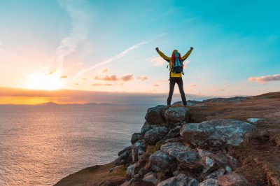 a man standing on a rocky beach