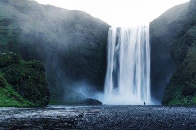 a waterfall with a mountain in the background